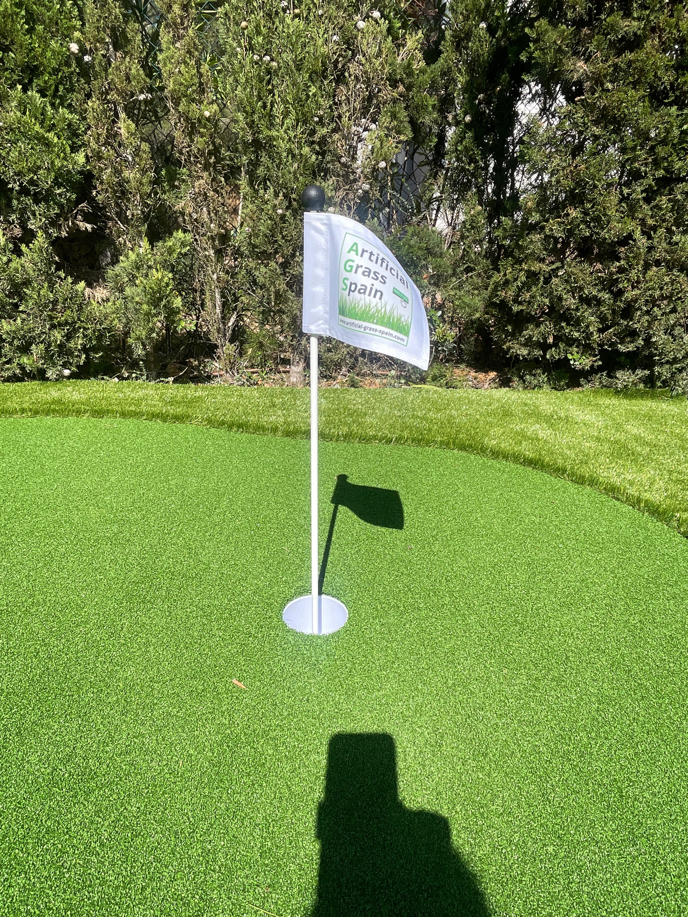 Golf flag on artificial grass putting green Spain