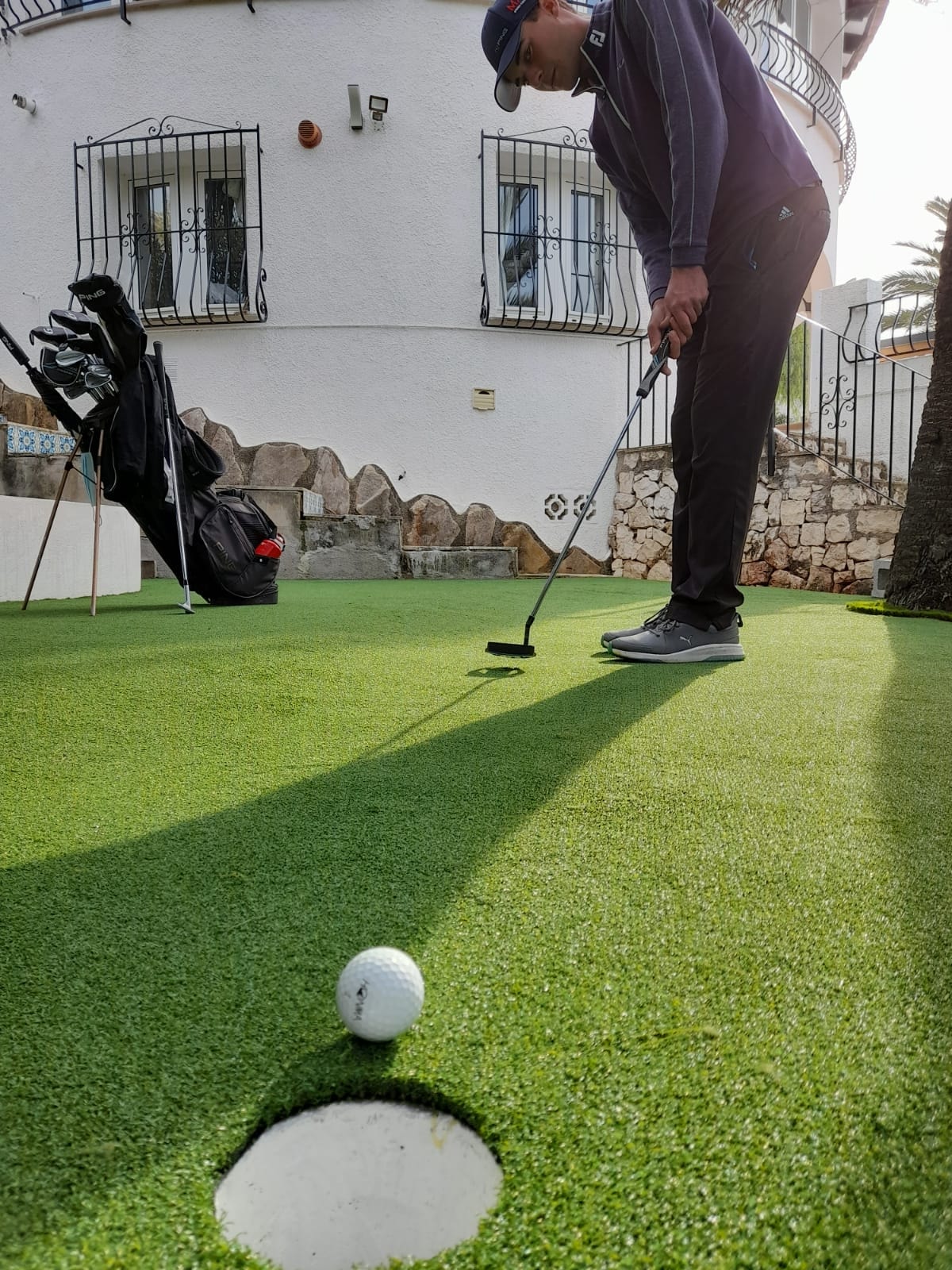 Home golf area with artificial grass ball rolling into hole Costa Blanca