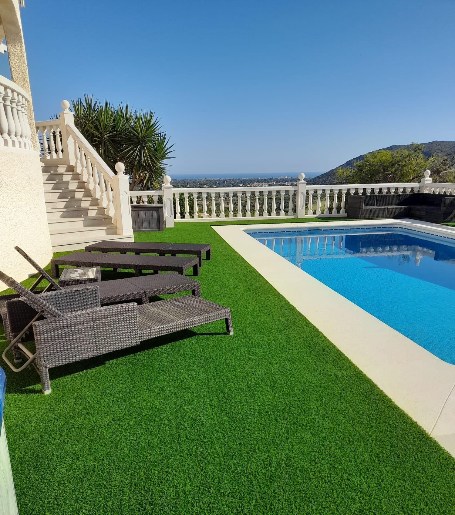 Pool surround with artificial grass sun loungers Costa Blanca