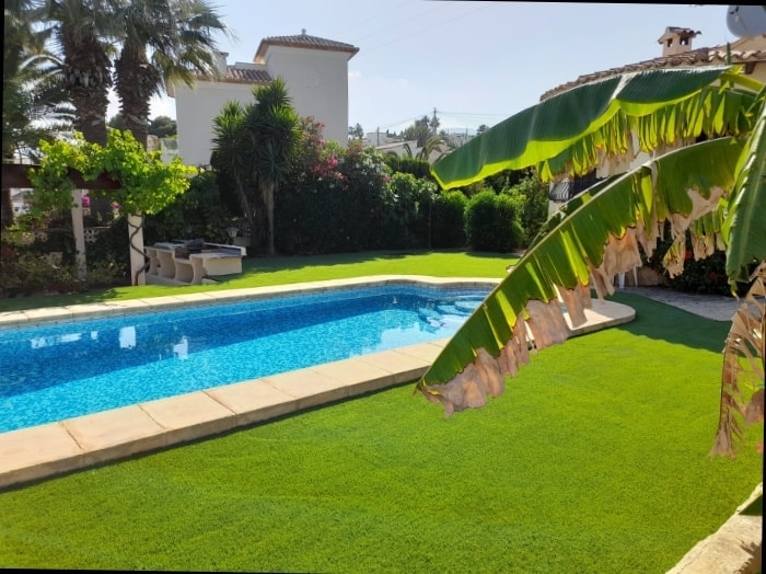 Villa pool garden with artificial grass and tropical planting Costa Blanca