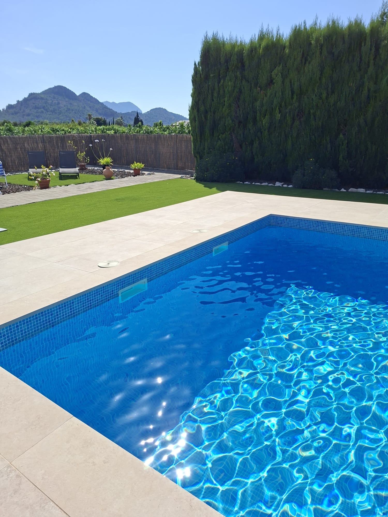 Pool terrace artificial grass with mountain backdrop Spain