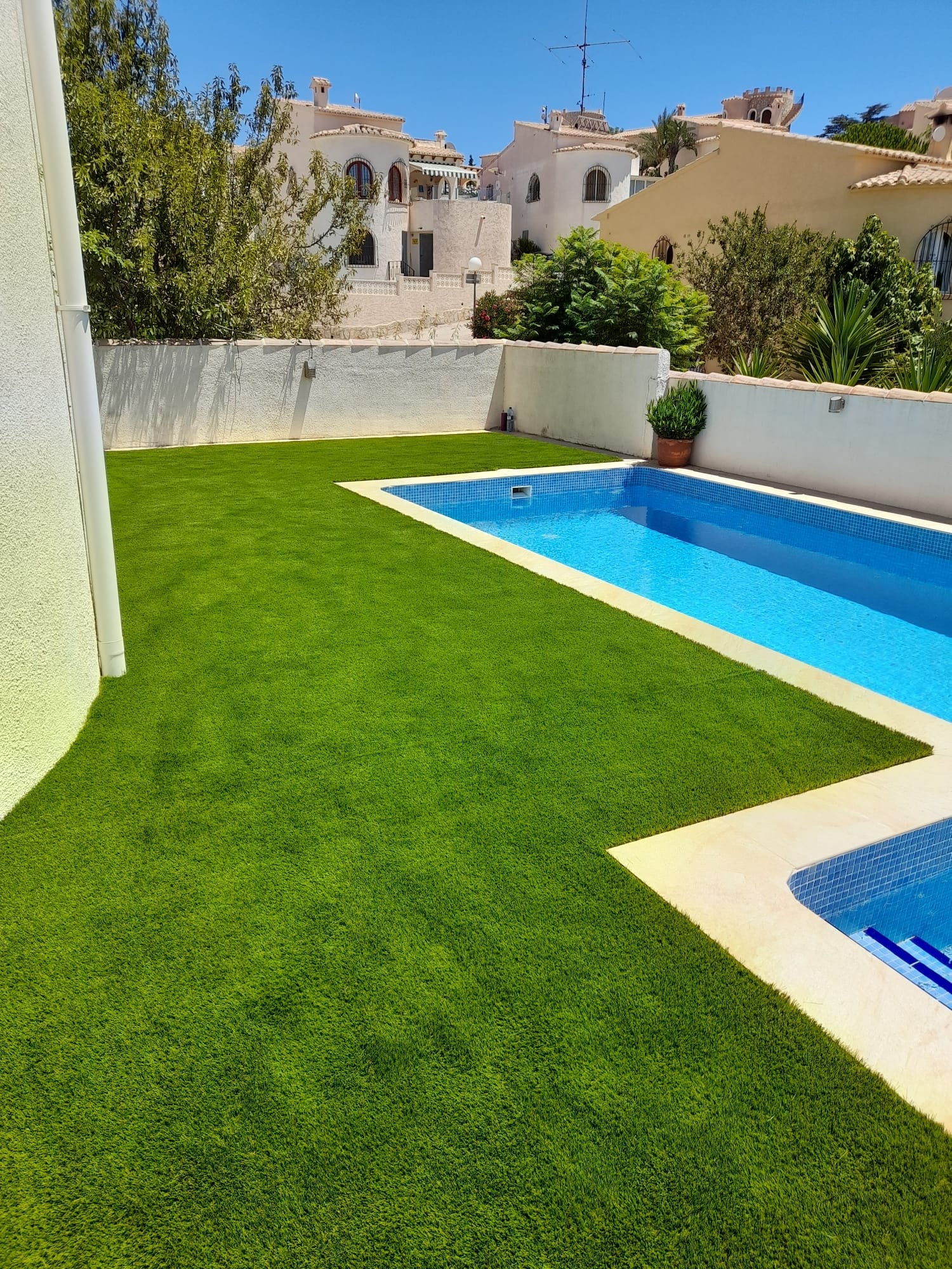 Large villa garden pool with artificial grass tropical planting Spain