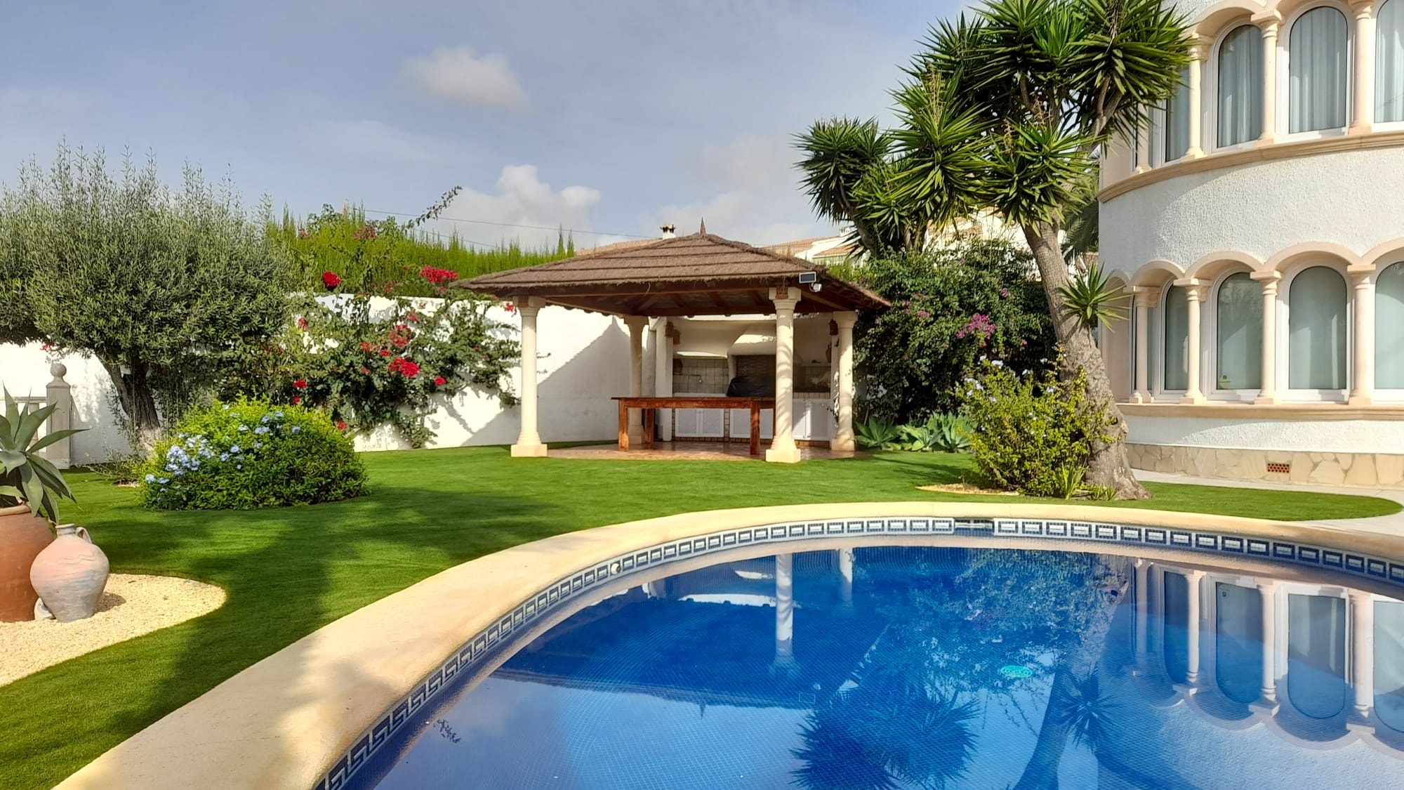 Luxury villa garden with pool and gazebo artificial grass Spain